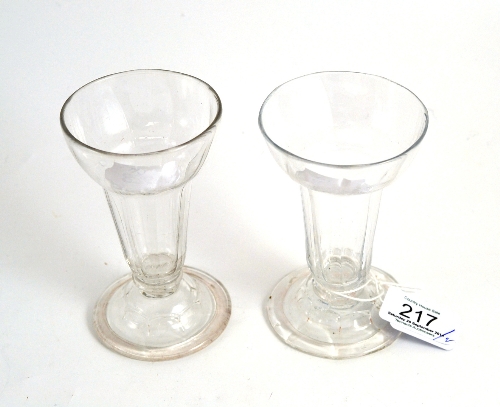 A pair of mid 18th century jelly glasses, with blade knopped stems and folded feet, 11.5cm high