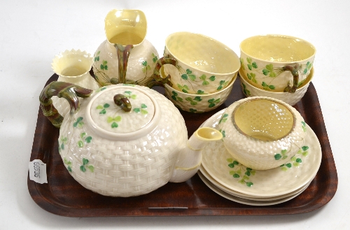 A Belleek shamrock and basket moulded tea set and a similar vase