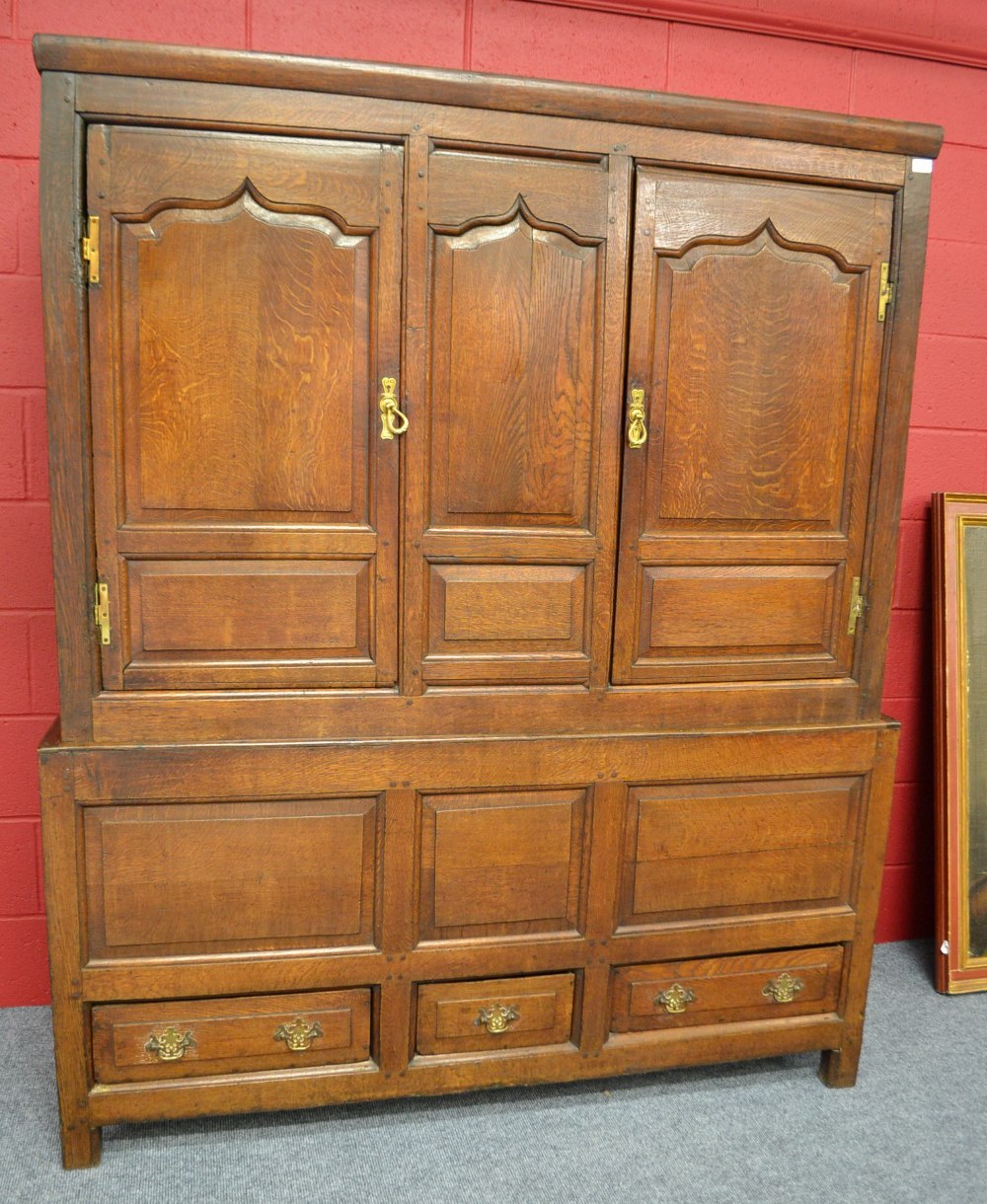 An 18th Century Joined Oak Livery Cupboard, with fielded panel doors enclosing later shelves, the
