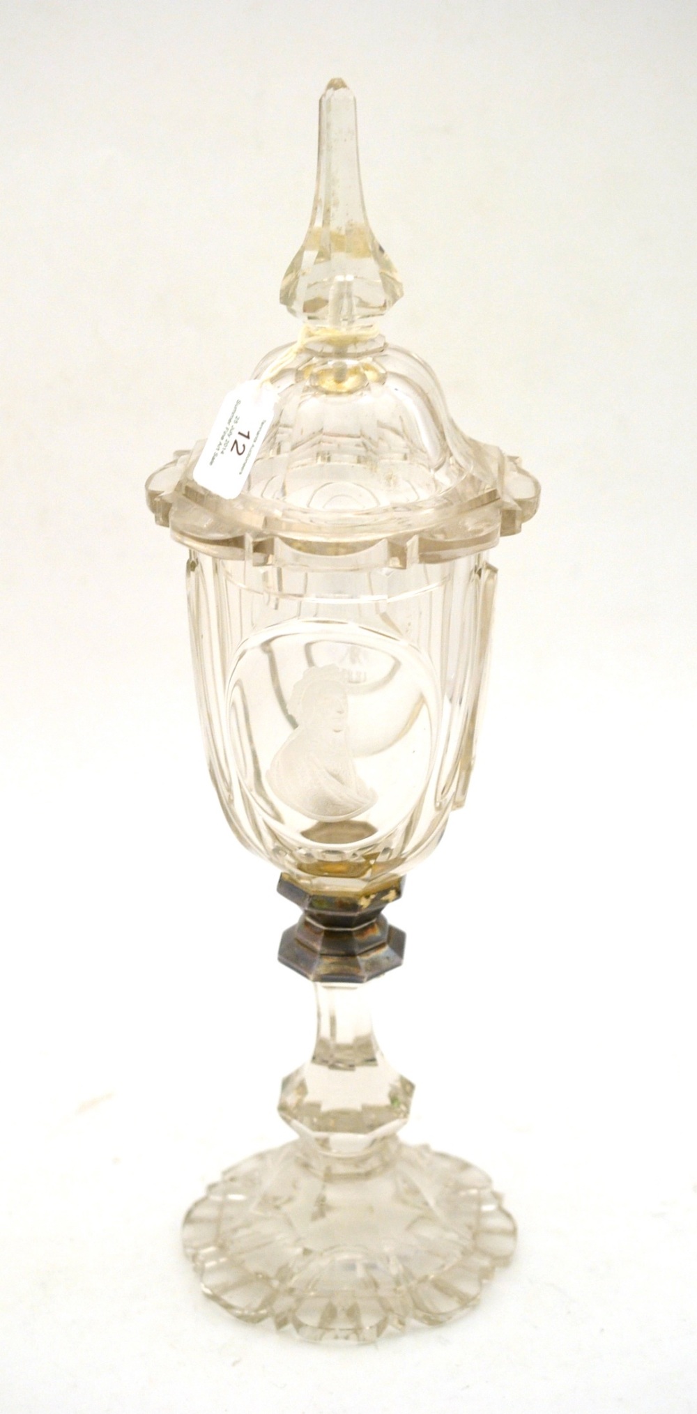 A Bohemian Glass Goblet and Cover, dated 1883, with minaret finial, the octagonal body engraved