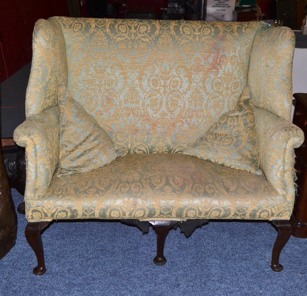 A George III Wing Back Sofa, recovered in worn green and yellow fabric, with rounded arm supports