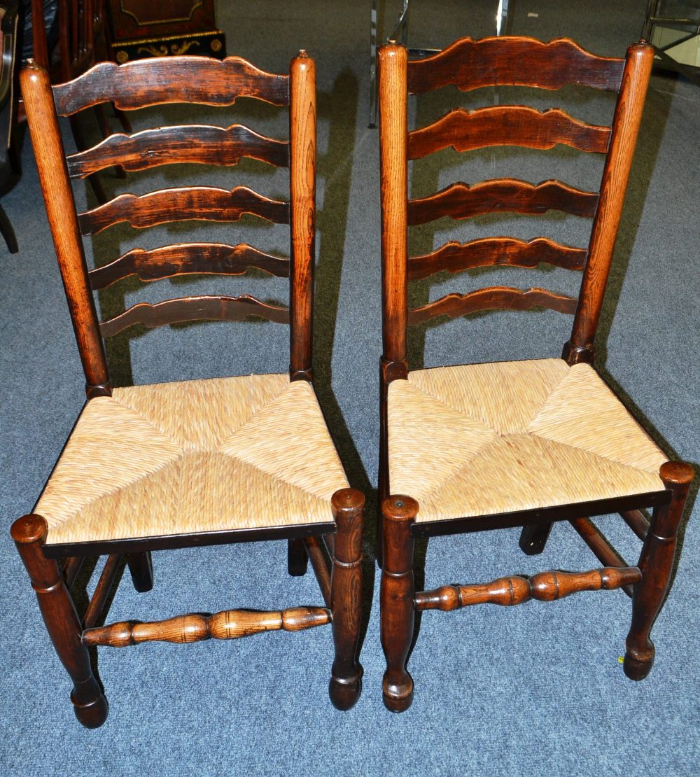 A Harlequin Set of Eight Lancashire Ash Ladderback Chairs, the wavy shaped back supports above rush