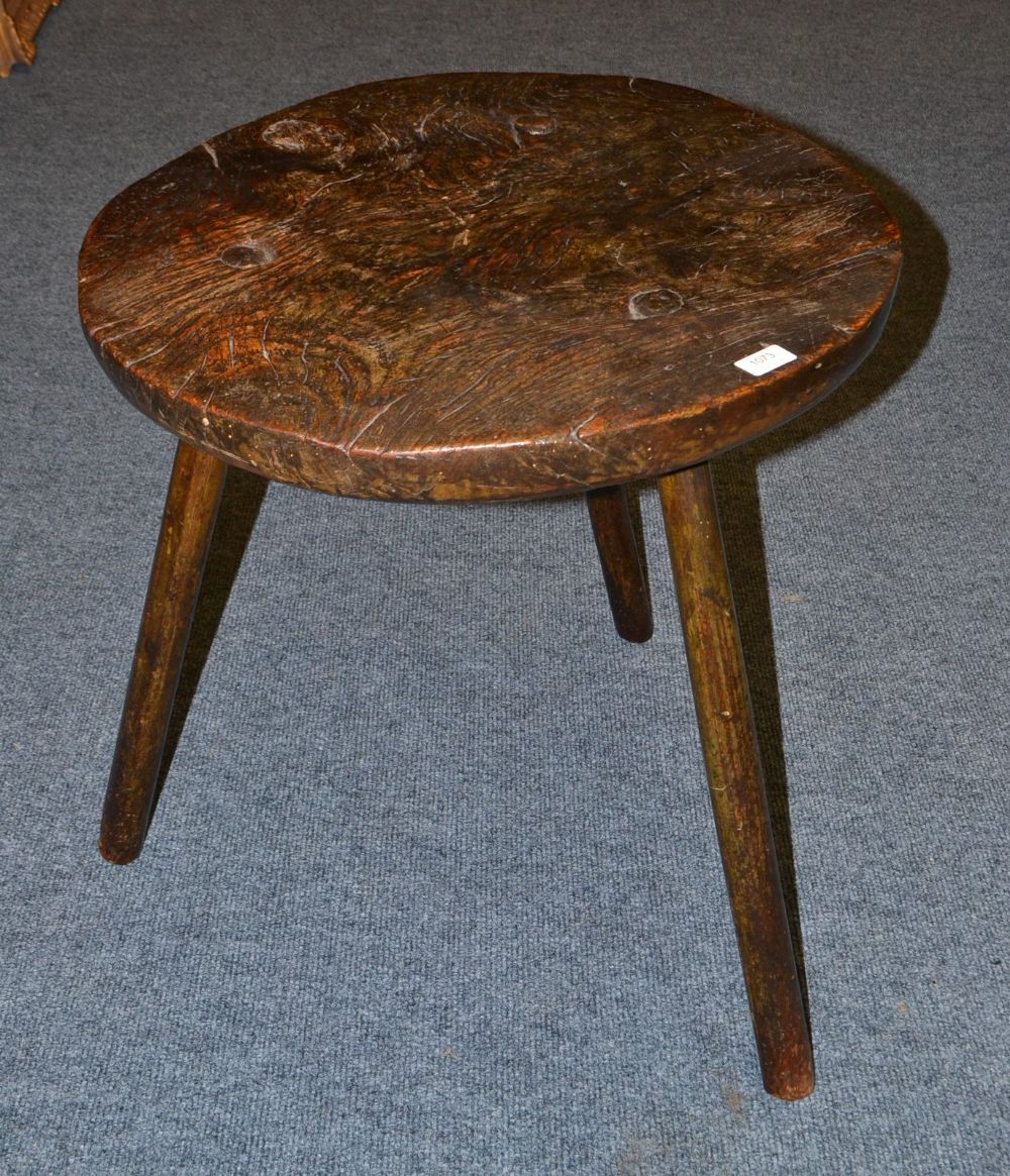 An English Oak Cricket Table, early 19th century, the circular top above three plain chamfered