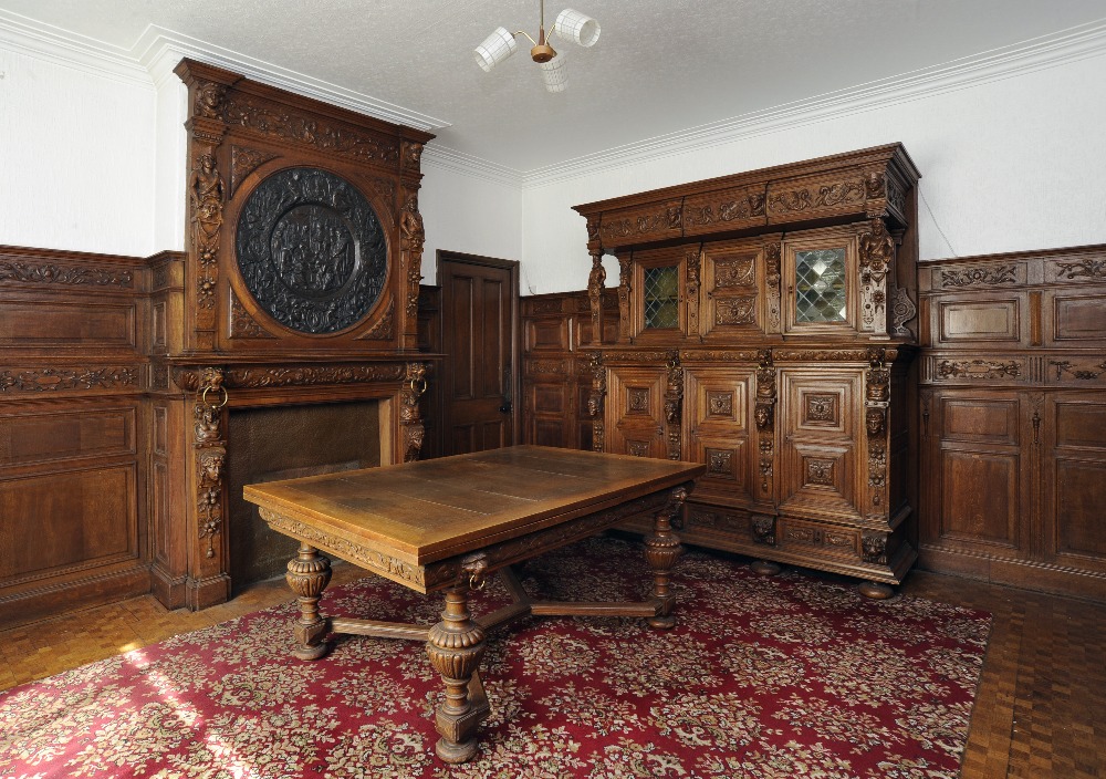A Victorian Carved Oak Fireplace, in 17th century style, the upper section with a carved frieze of