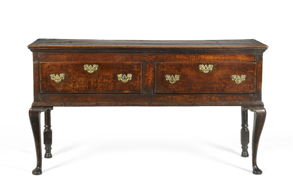 An 18th Century English Oak Sideboard Dresser, the moulded top above two deep drawers with fielded