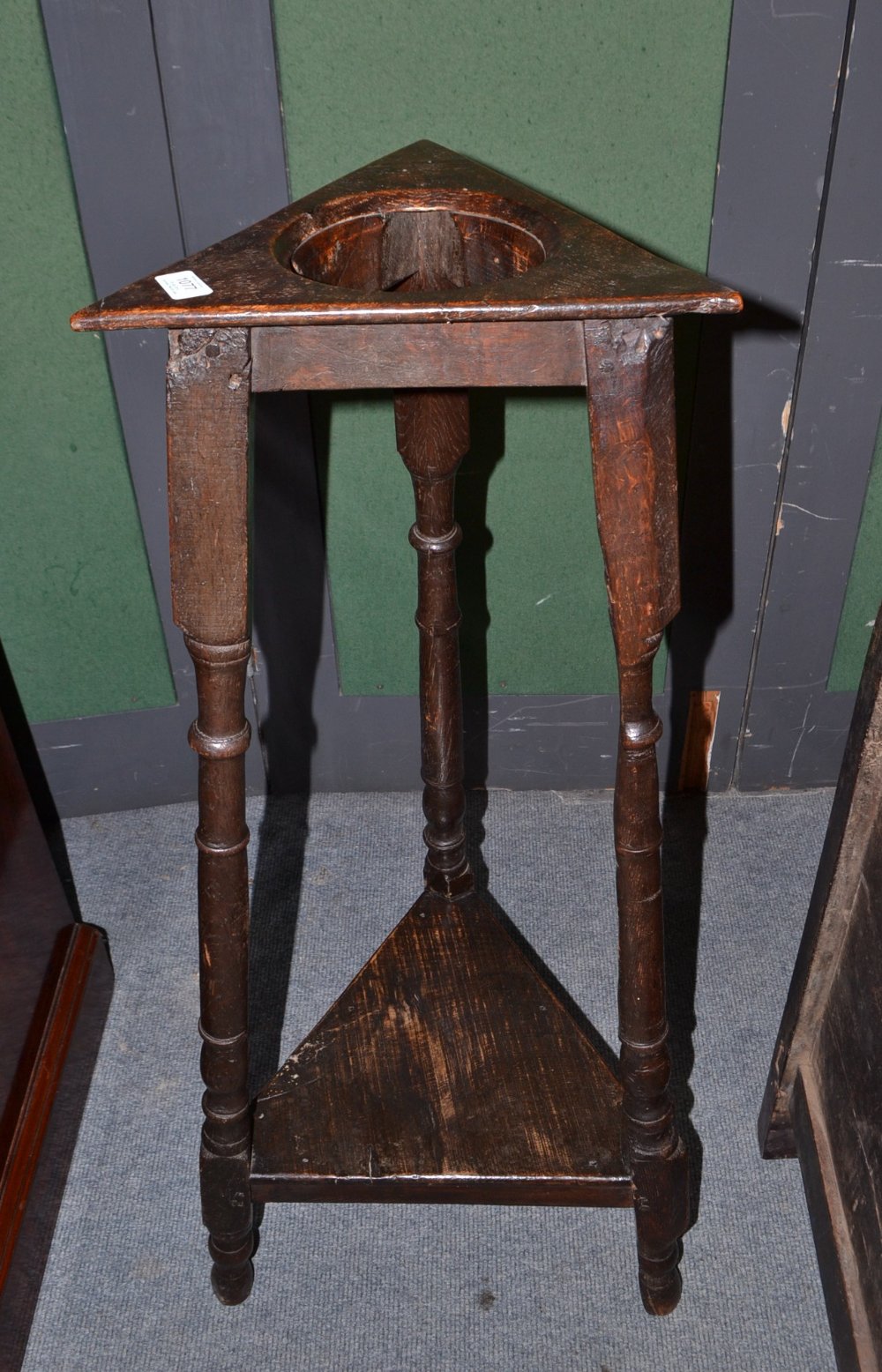 An English Oak Domestic Mortar Stand, circa 1730, with triangular aperture, raised on ring turned