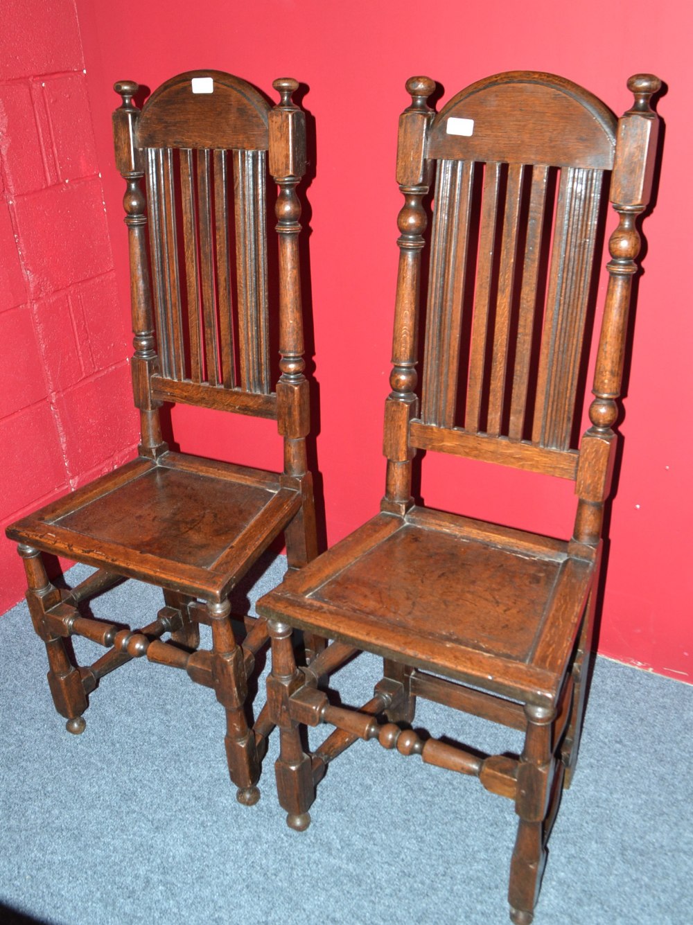 A Pair of Late 17th Century English Joined Oak Back Stools, with arched top rails and moulded back