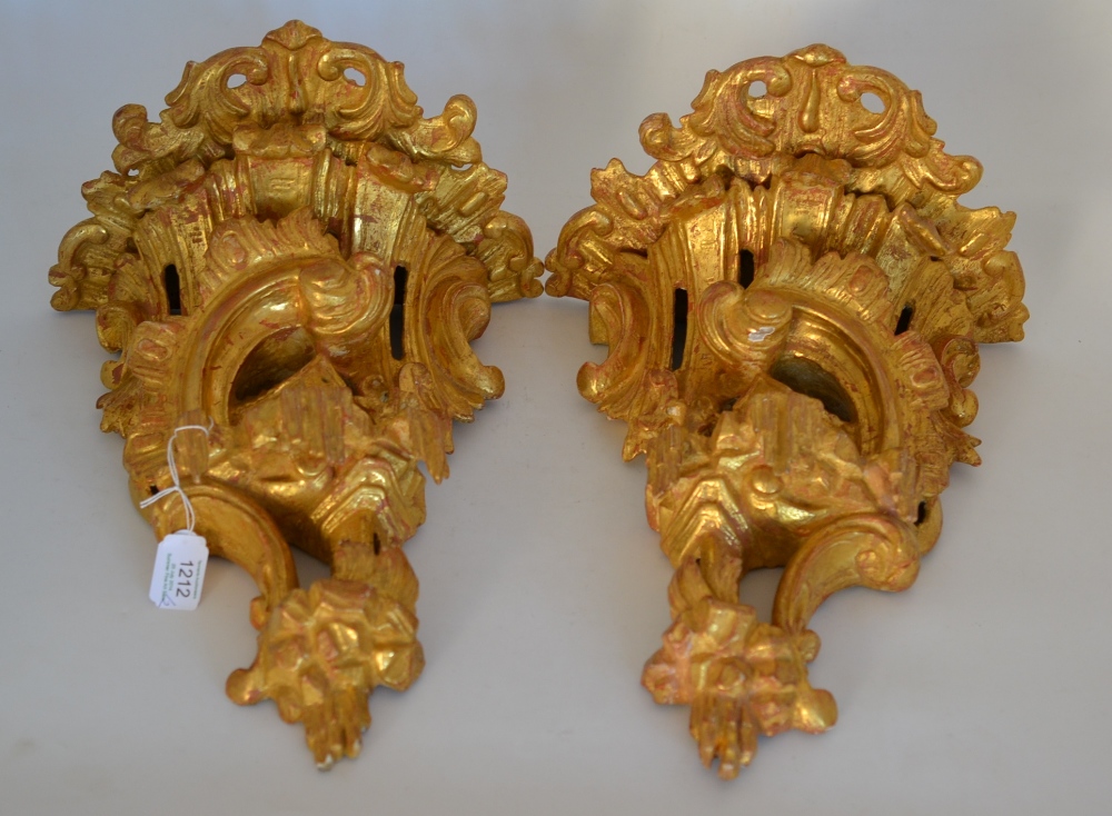 A Pair of Carved Giltwood and Gesso Wall Brackets, each carved with rococo scrolls and pavilions