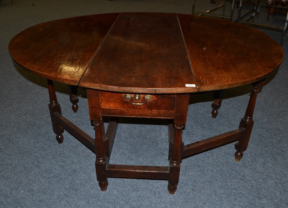 An 18th Century English Joined Oak Six-Seater Double Gateleg Table, with two rounded drop leaves