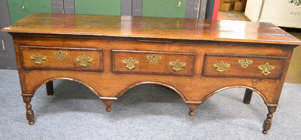 A Mid 18th Century English Oak and Mahogany Crossbanded Low Dresser, the plank top above three