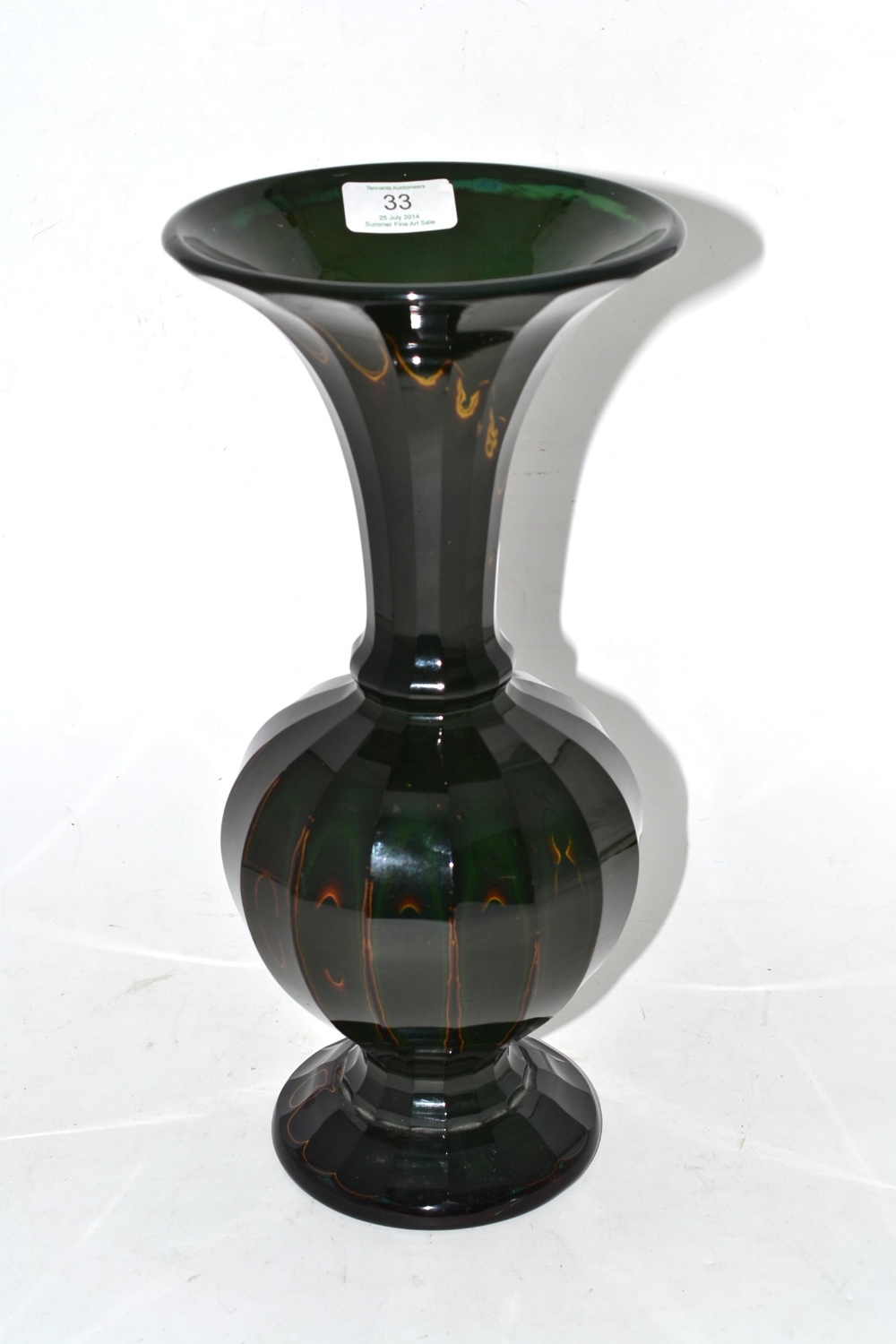 A Lithyalian Green Glass Vase, mid 19th century, of panelled ovoid form with trumpet neck and