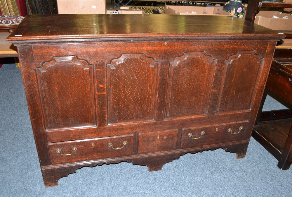 An 18th Century Joined Oak Lancashire Chest, the hinged lid above four fielded panels with three