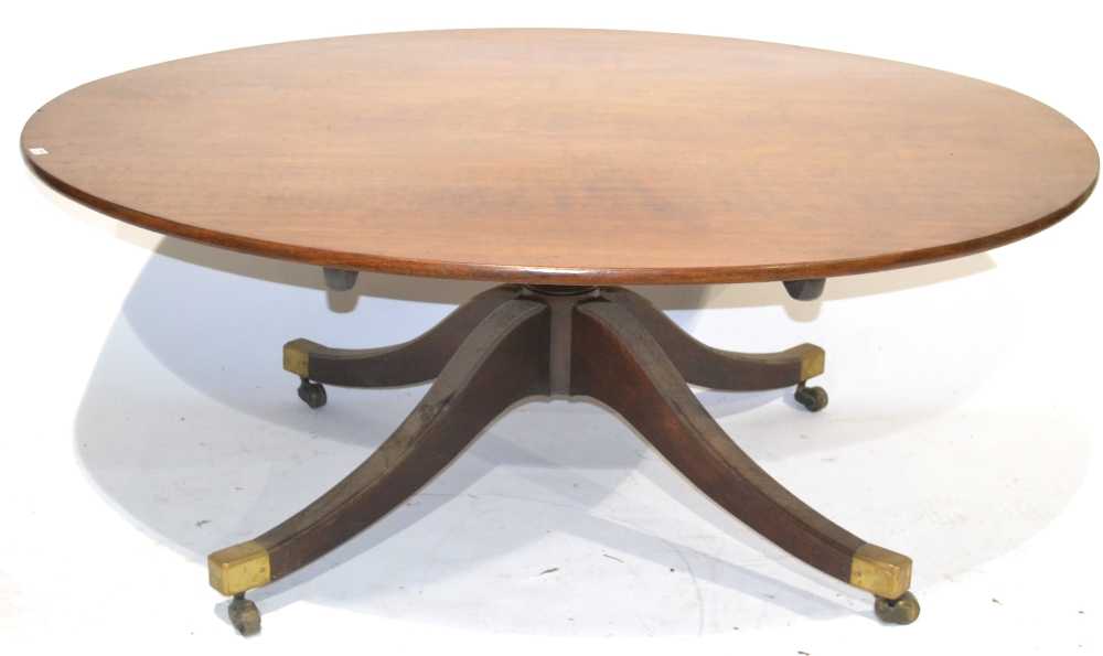 A George III Design Dining Table, the oval flip-top above a turned gun barrel support on four