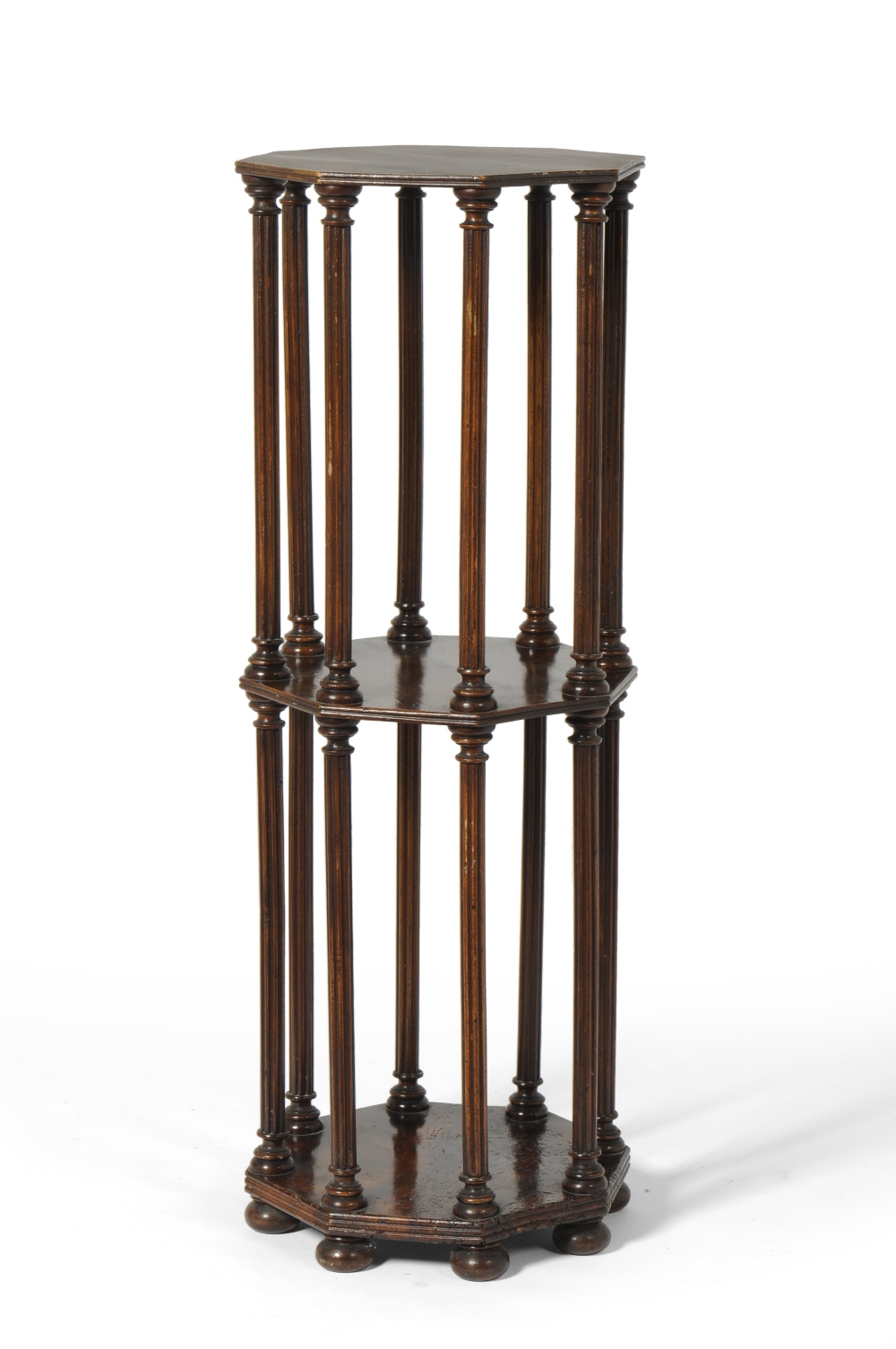 A Stained Beech Octagonal Bookstand, with turned and fluted column supports, on flattened bun