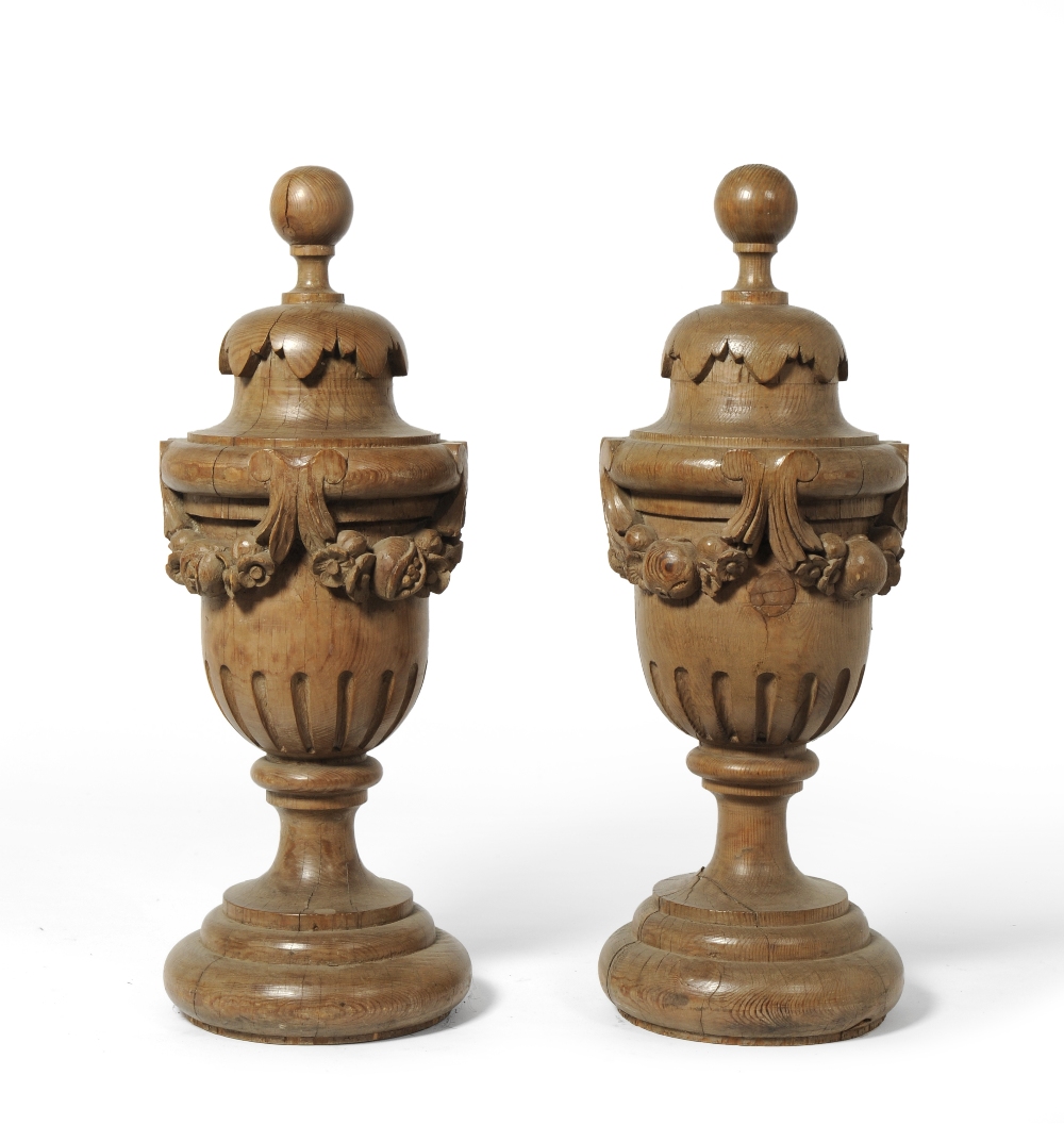 A Pair of 19th Century Carved Pine Baroque Style Pedestal Urns, each carved with garlands of flowers