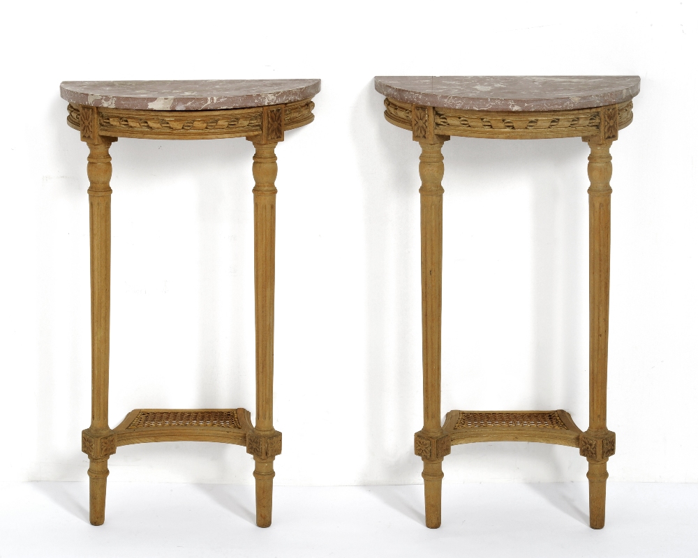 A Pair of Carved Pine Demi-Lune Console Tables, with pink and white veined marble top, carved frieze