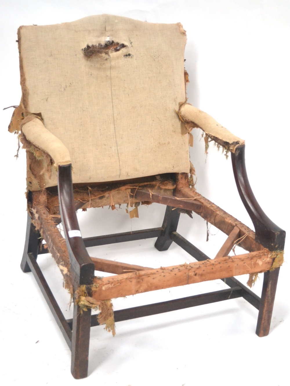 A George III Mahogany Library Armchair, the frame late 18th century, with downswept arms on