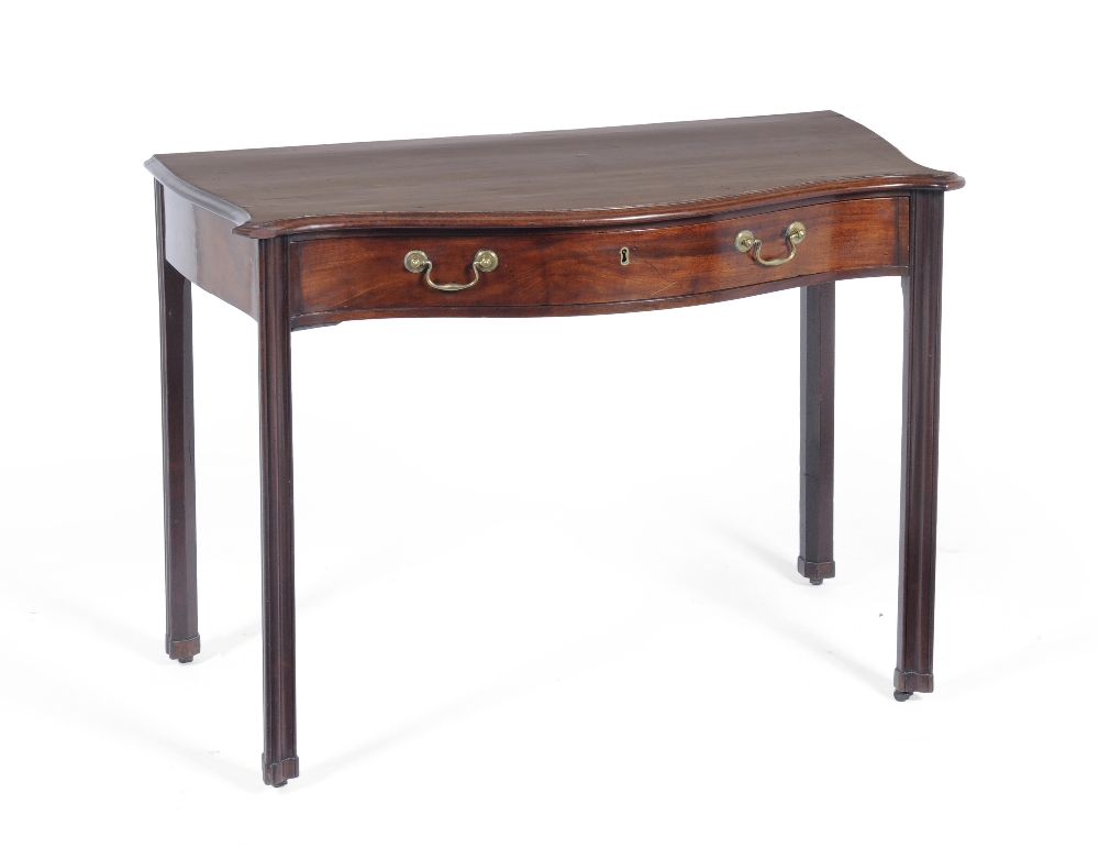 A George III Mahogany Side Table, of serpentine form, the moulded top with eared corners above a