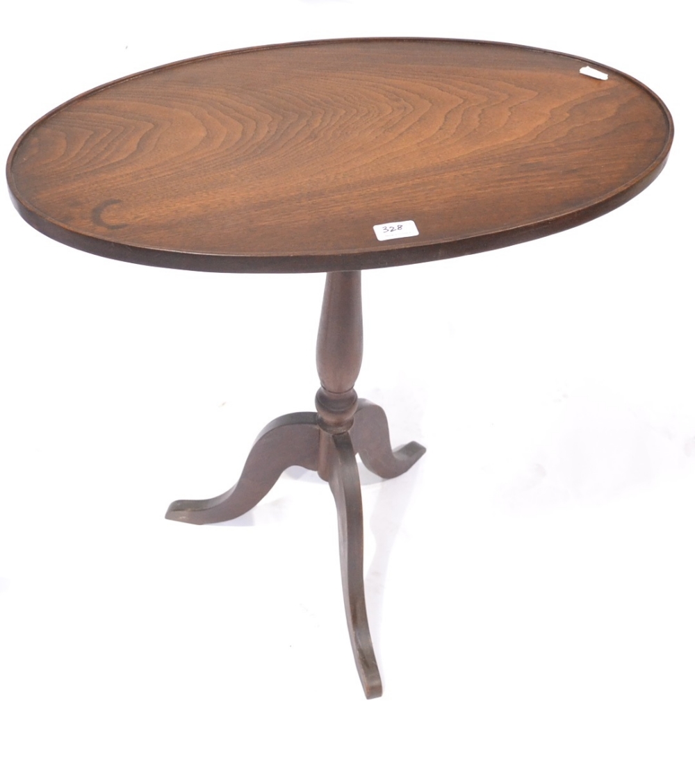 A 20th Century Mahogany Fliptop Tripod Table, the oval top on a turned vasiform support, 68cm by - Image 3 of 3