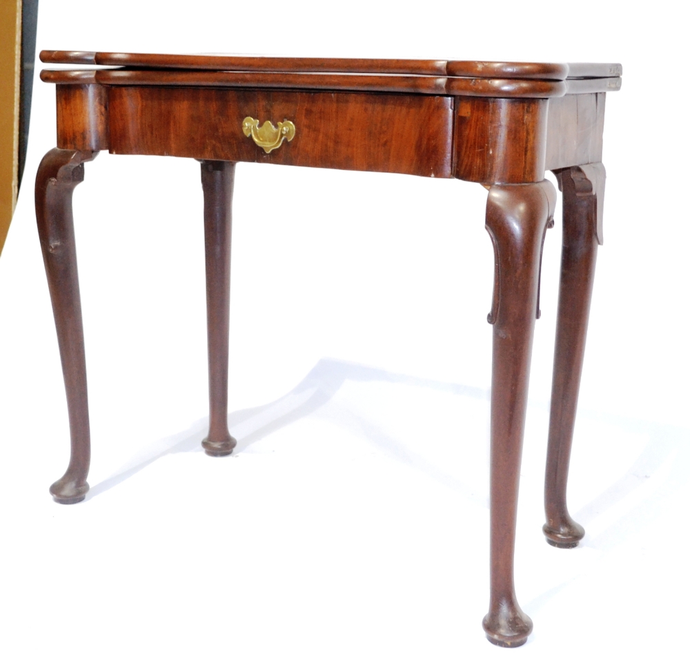 A George II Mahogany Foldover Tea Table, 18th century and later, with eared corners above a single