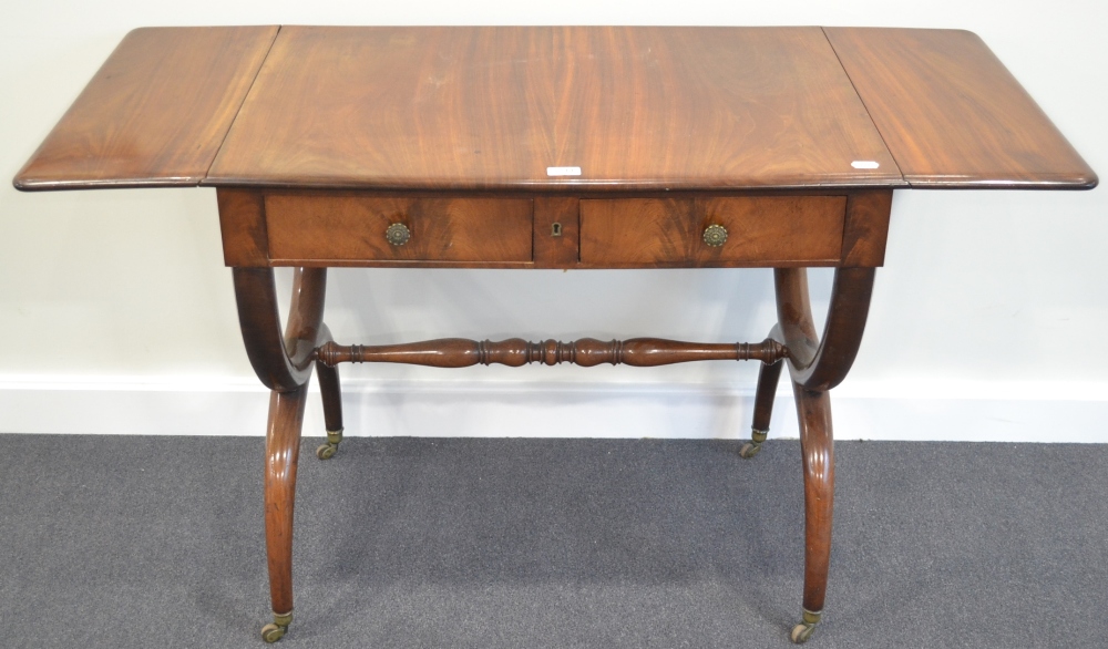 A North European Mahogany Sofa Table, mid 19th century, the rounded drop leaves above two frieze