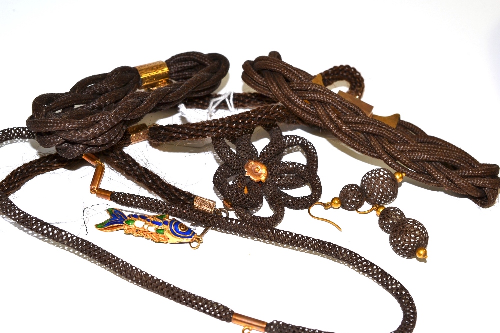 Three Victorian woven hair bracelets with gilt metal mounts and attached heart shaped mourning fob,