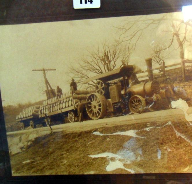 Early American albumen photograph of a steam traction engine towing two trailers of beer barrels,