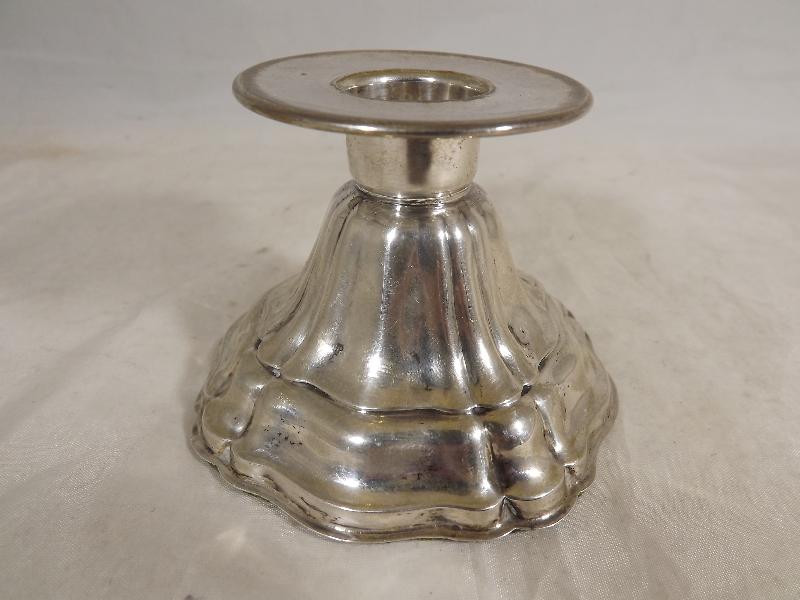 A German silver table centre candlestick of dwarf waterfall design with a brimmed collar and green