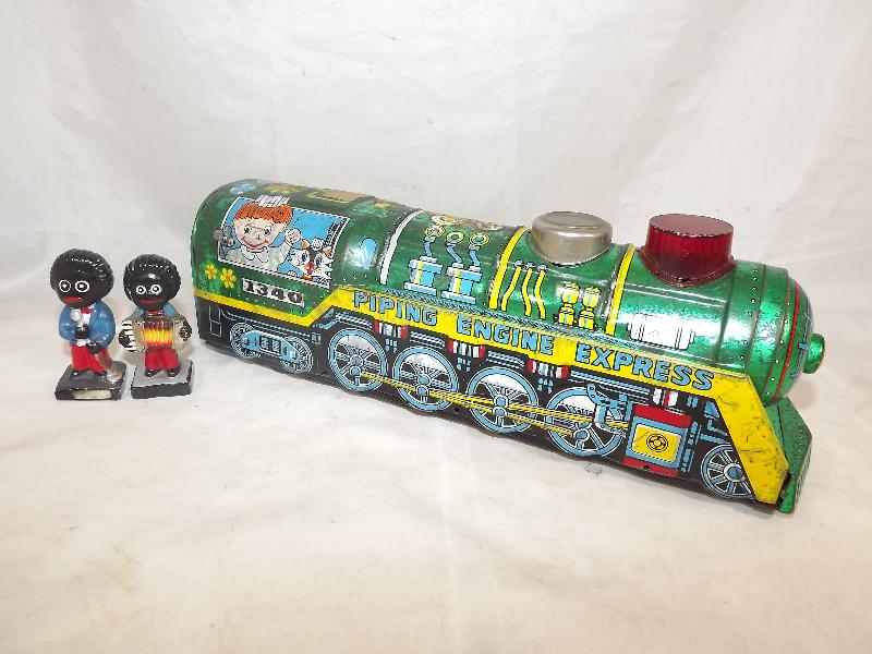 A tinplate Kanto train pat No. 440817 469127 and two Robinsons figures (3)