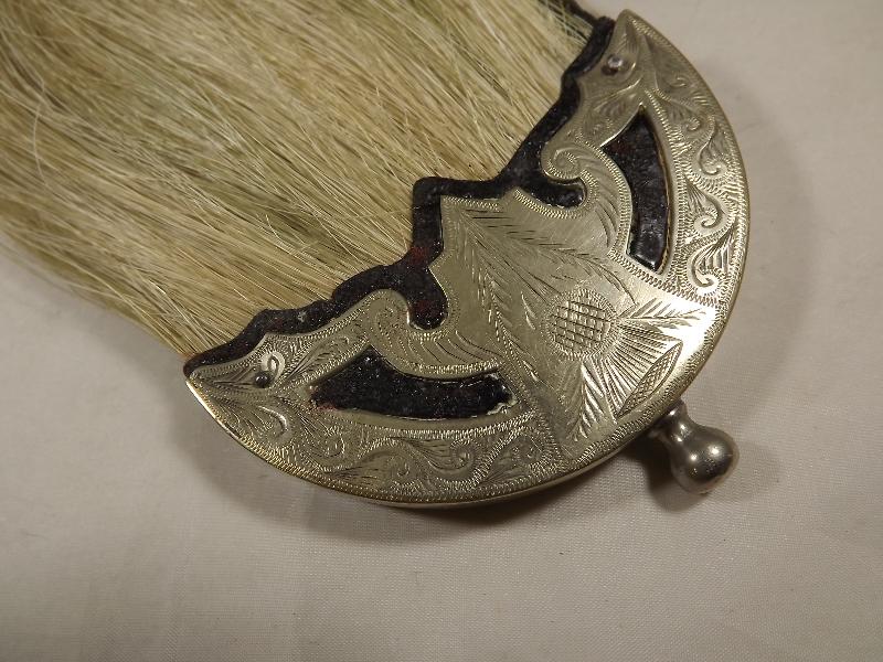 An early to mid 20th century horsehair sporran with white metal mount engraved with thistle and