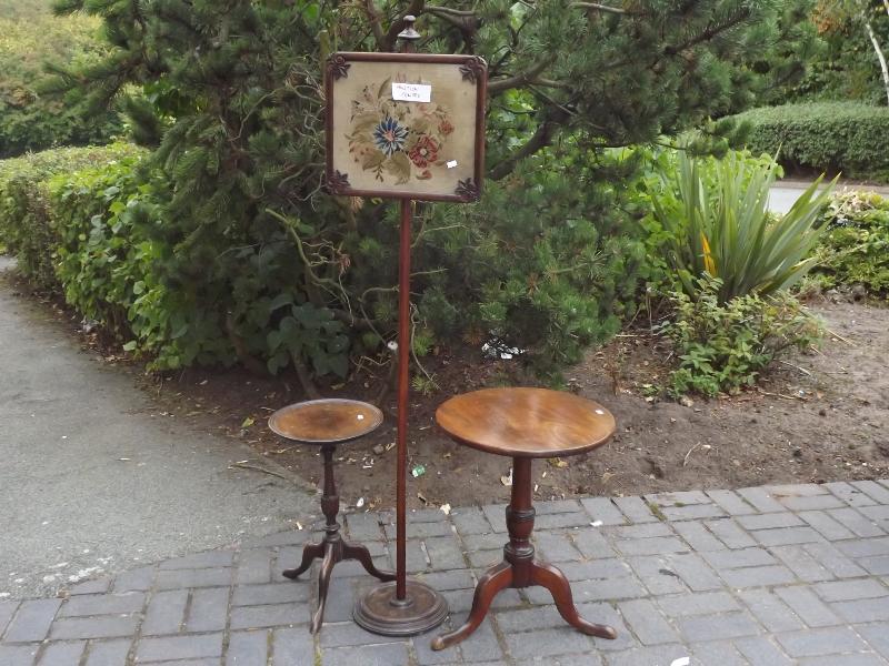 A fire screen with floral embroidery within a glazed panel, a small wine table and mahogany table on
