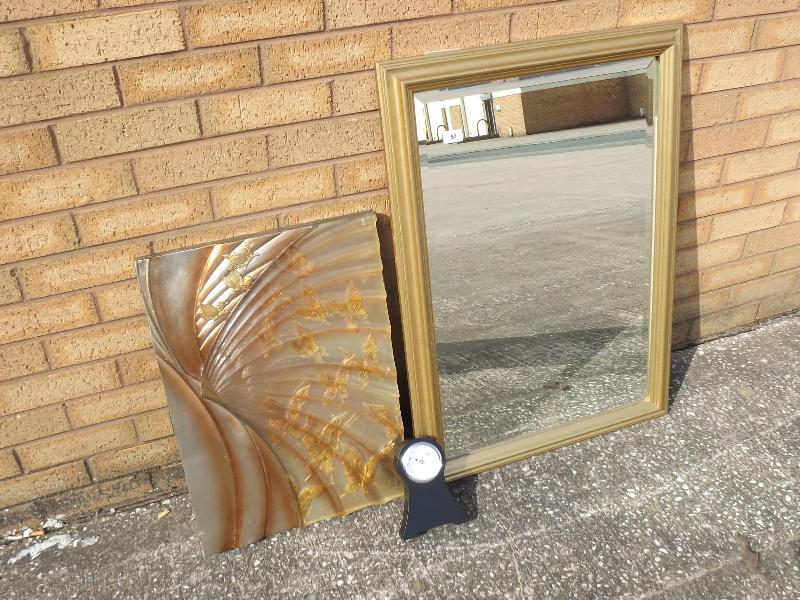 A gilt framed bevel edged wall mirror, 86cm x 60cm, an art glass wall hanging and a mantel clock