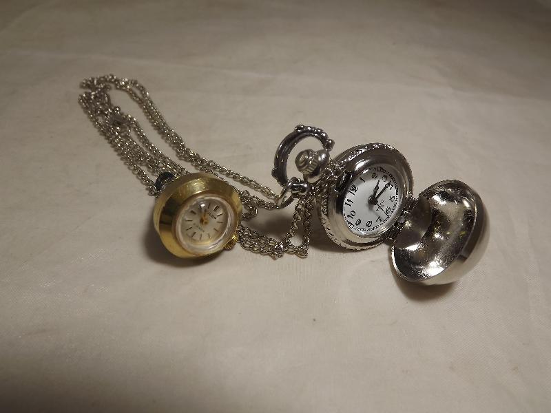 A white metal pocket watch with bullseye case and white metal chain and a Buler 17 jewel cone