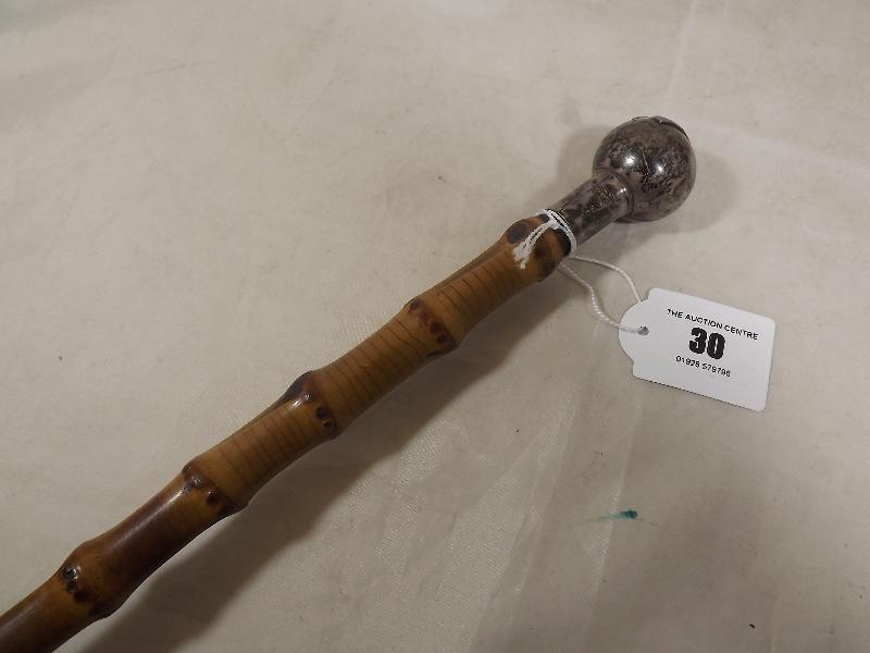 A cane swagger stick with hallmarked silver knob, Birmingham assay 1918 with Kings Own Regiment