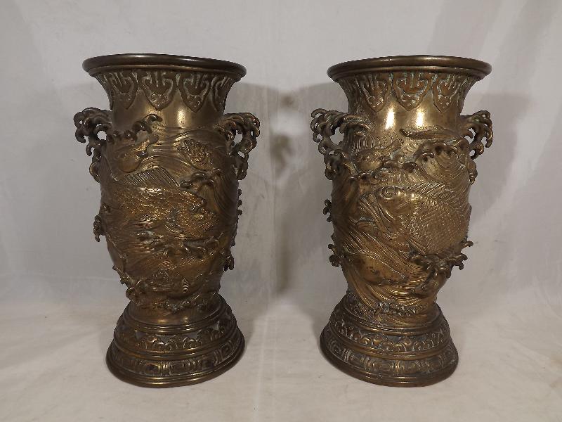 A pair of Japanese vases with relief decoration of fish and with handles in the form of finger