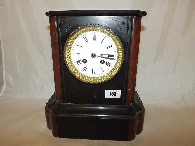 A French black marble cased mantel clock with and rouge royale marble decoration to the flanks, hour