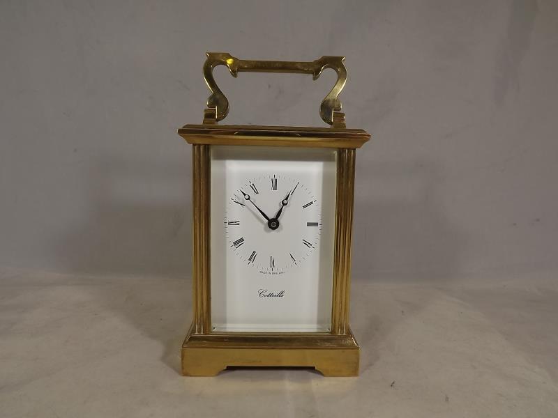 A good quality carrriage timepiece in a heavy brass and bevelled glass case having reeded square