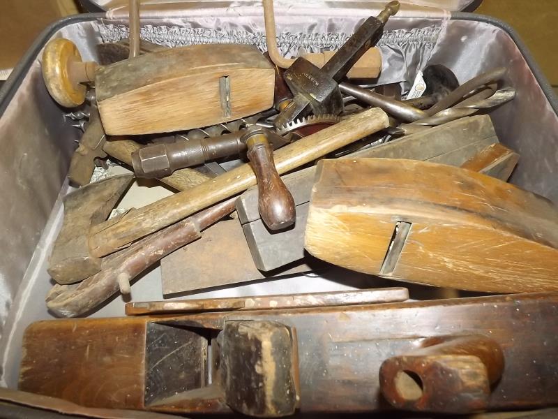 A vintage suitcase containing quantity of hand tools