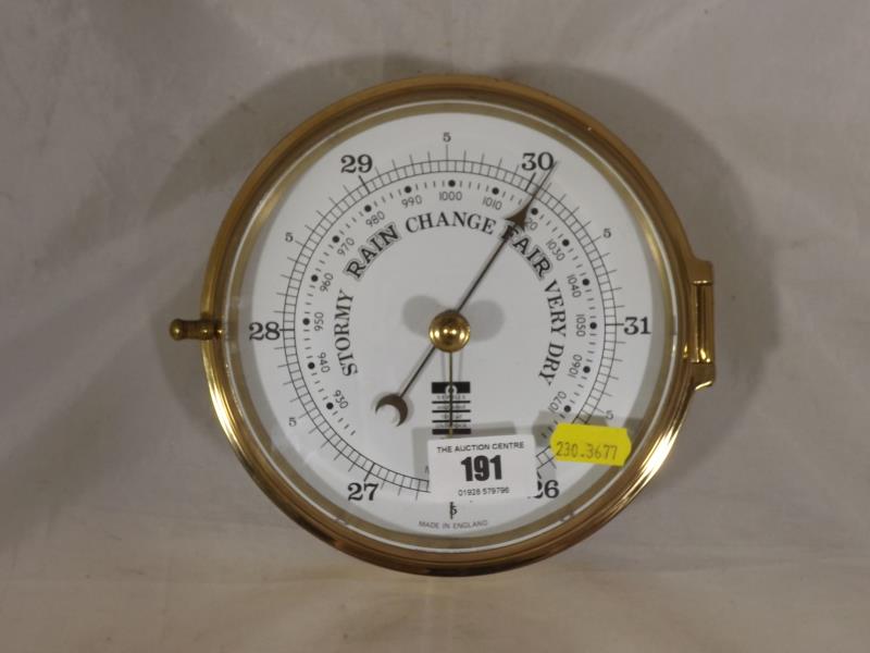 A brass cased wall mounted barometer made to match a ships clock by Sewills, Liverpool. Estimate £30