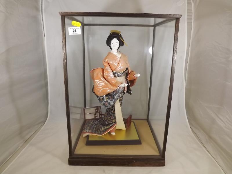 A hand painted Hakata doll in glass case, 49.5cm x 34cm x 31cm