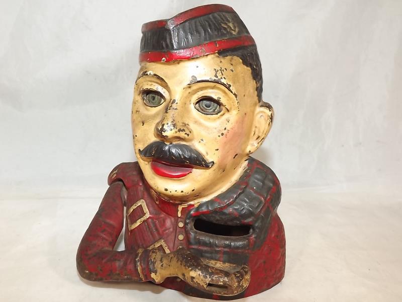 An original Kiltie cast iron mechanical money bank by John Harper, ca 1930's, 17.5 cm (high) -