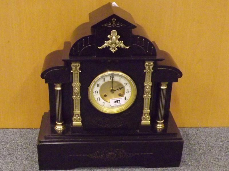 A French black marble mantel clock, the eight day movement dated 1900, bell chime, Roman numerals,