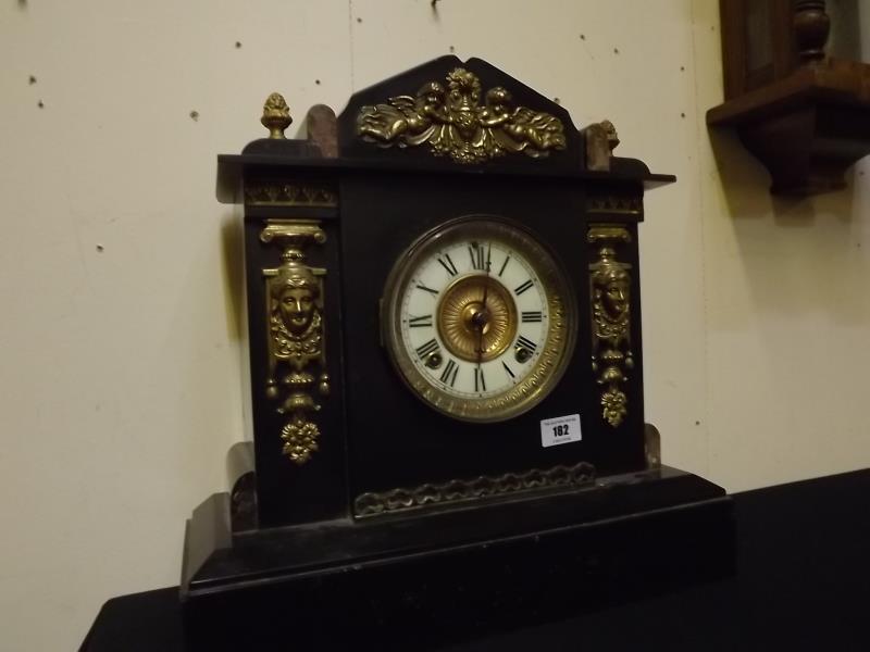 An American movement black marble cased mantel clock, the architectural form case embellished with