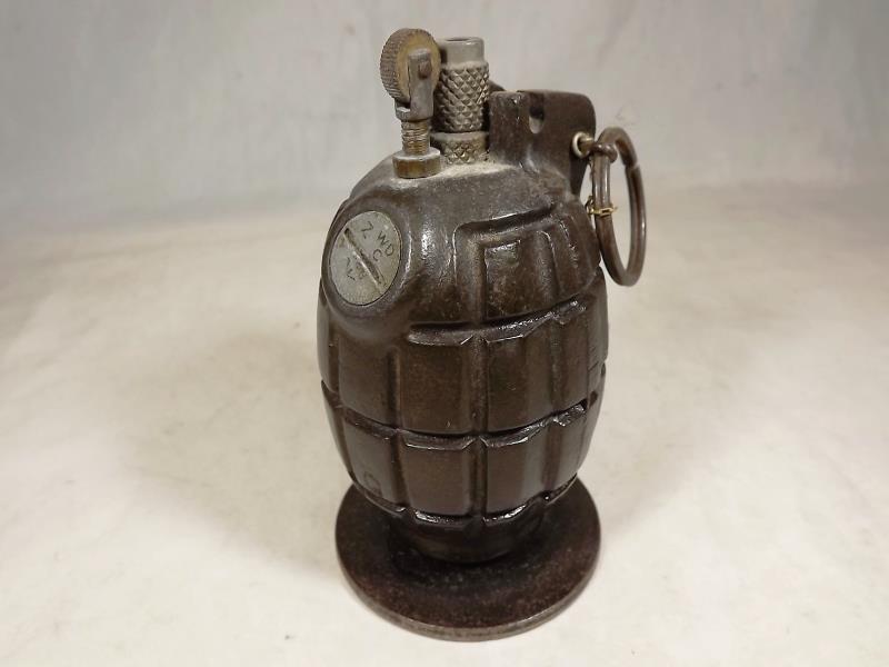 A table lighter in the form of a hand grenade with impressed marks to the base 1FS 6/4, 11cm (h)