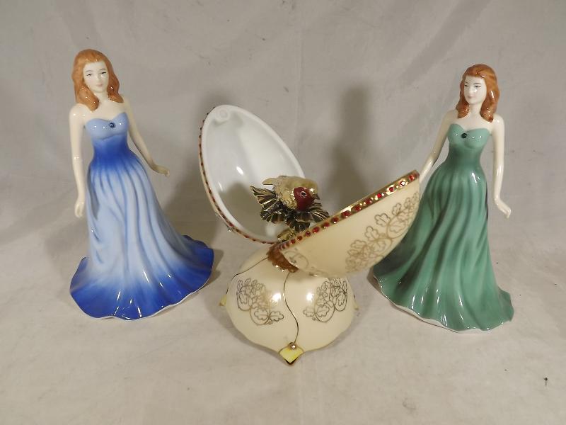 Two Royal Doulton figurines entitles Sapphire and Emerald and a ceramic musical box depicting a