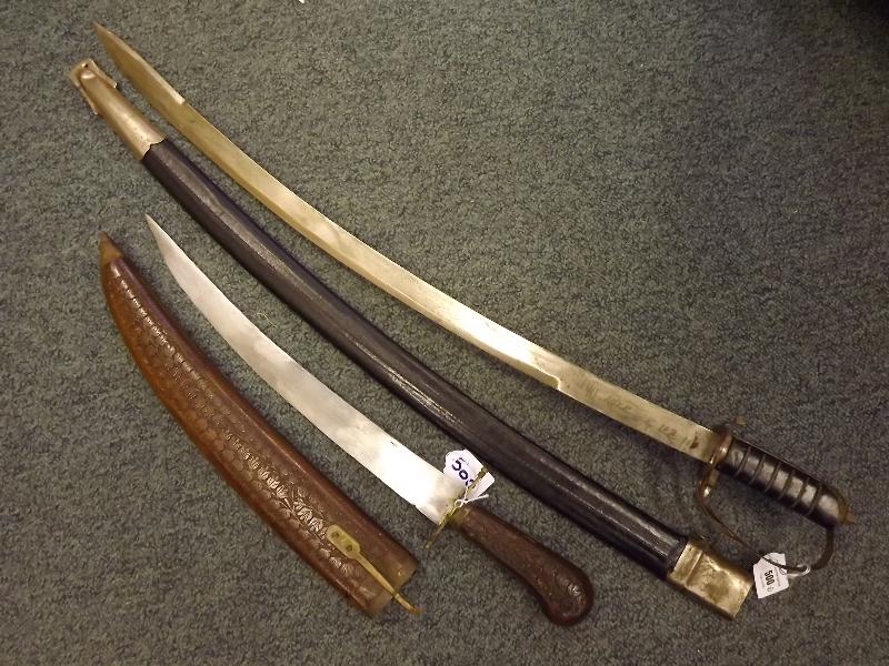 A replica curved bladed cavalry saber with inscription to the blade, complete with sheath, approx