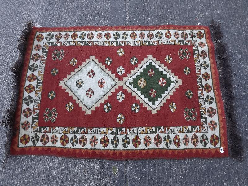 A Romanian wool rug, approx 153 cm x 92 cm and an Eastern wool rug, approx 150 cm x 104 cm - (2)