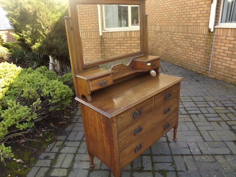 A good quality early 20th century dressing table with bevel edged mirror back above two miniature