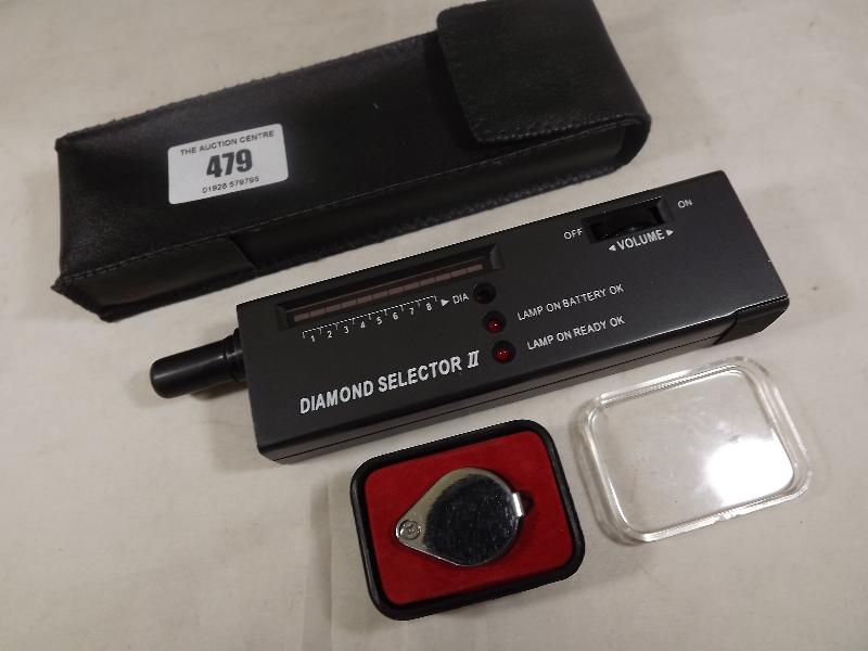 A Diamond Tester marked 'Diamond Selector II' with soft case and a jeweller's loupe 10 x 17 mm,