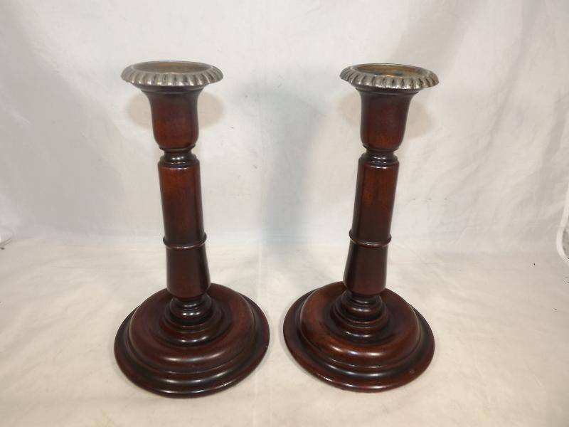 A pair of good quality heavy carved rosewood candlesticks with plated sconce